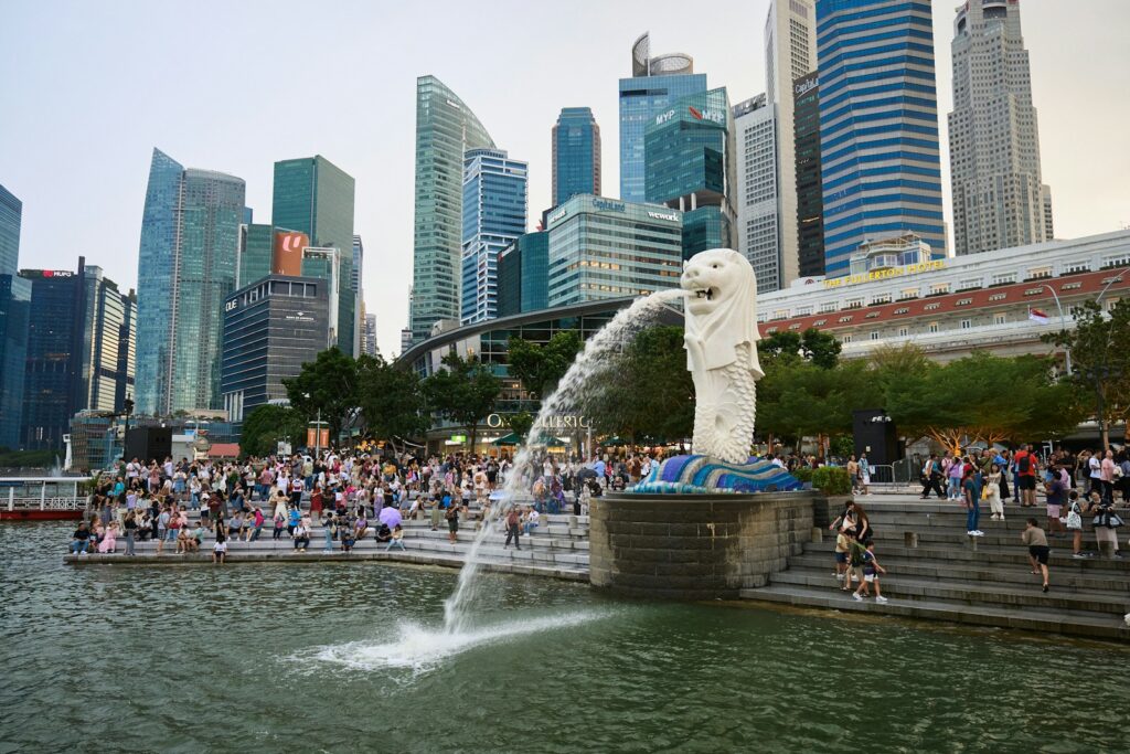 A crowd of people standing around a water fountain